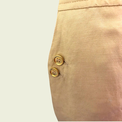 Button detail on tan skirt on beige background