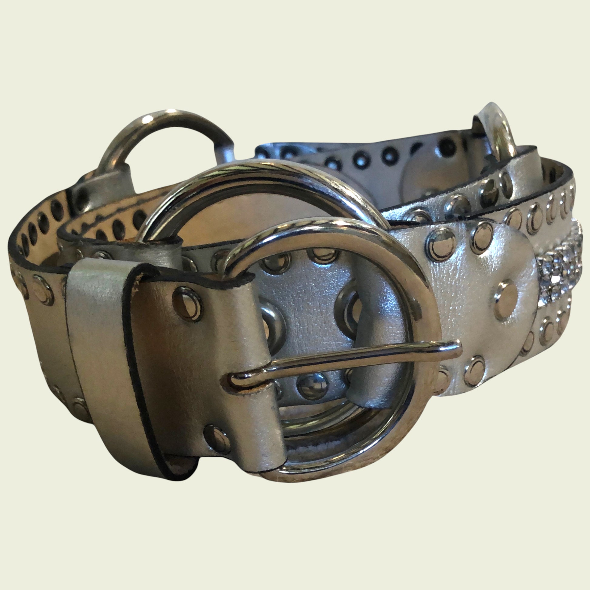 Silver studded belt on a beige background