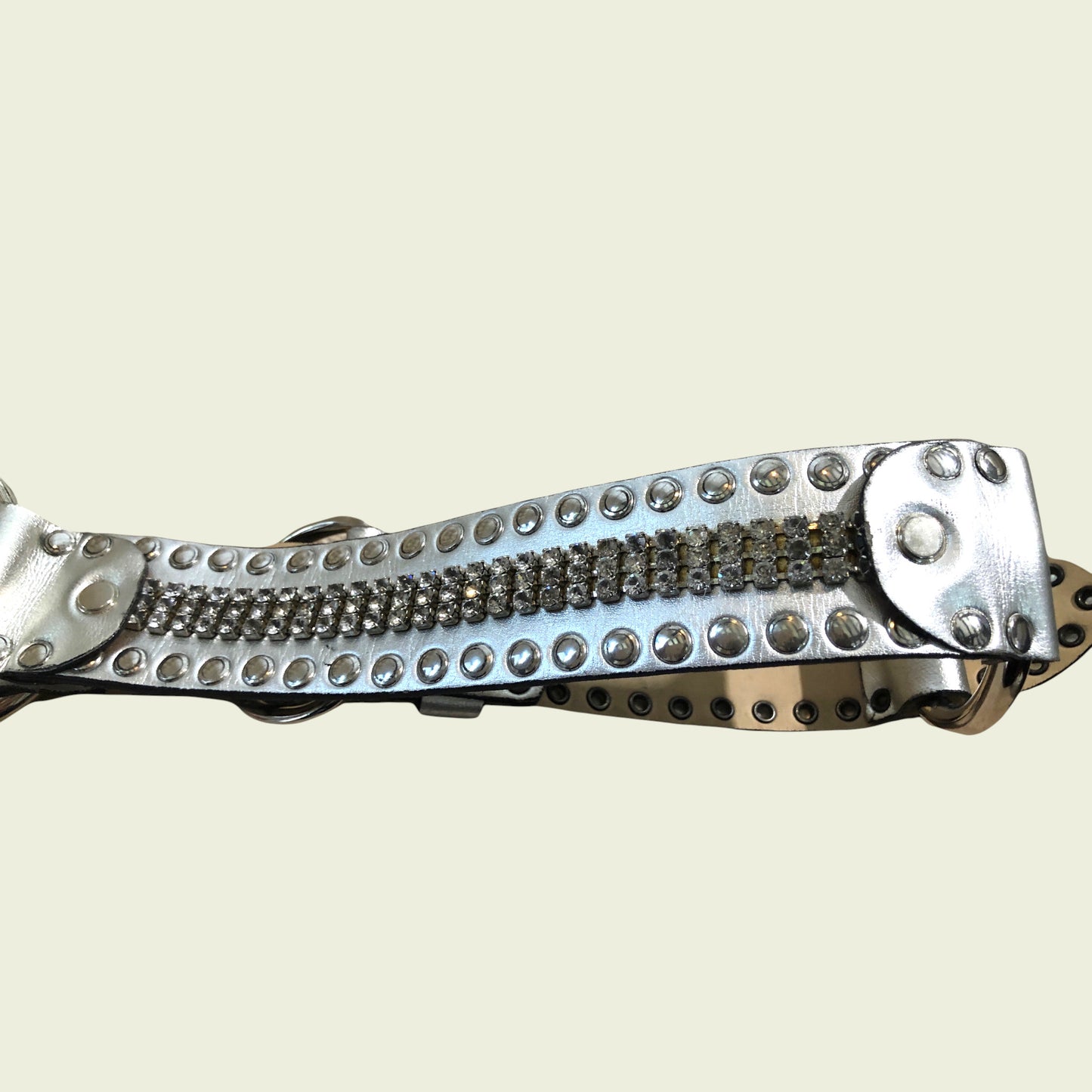 Metallic belt with chain design on a light beige background