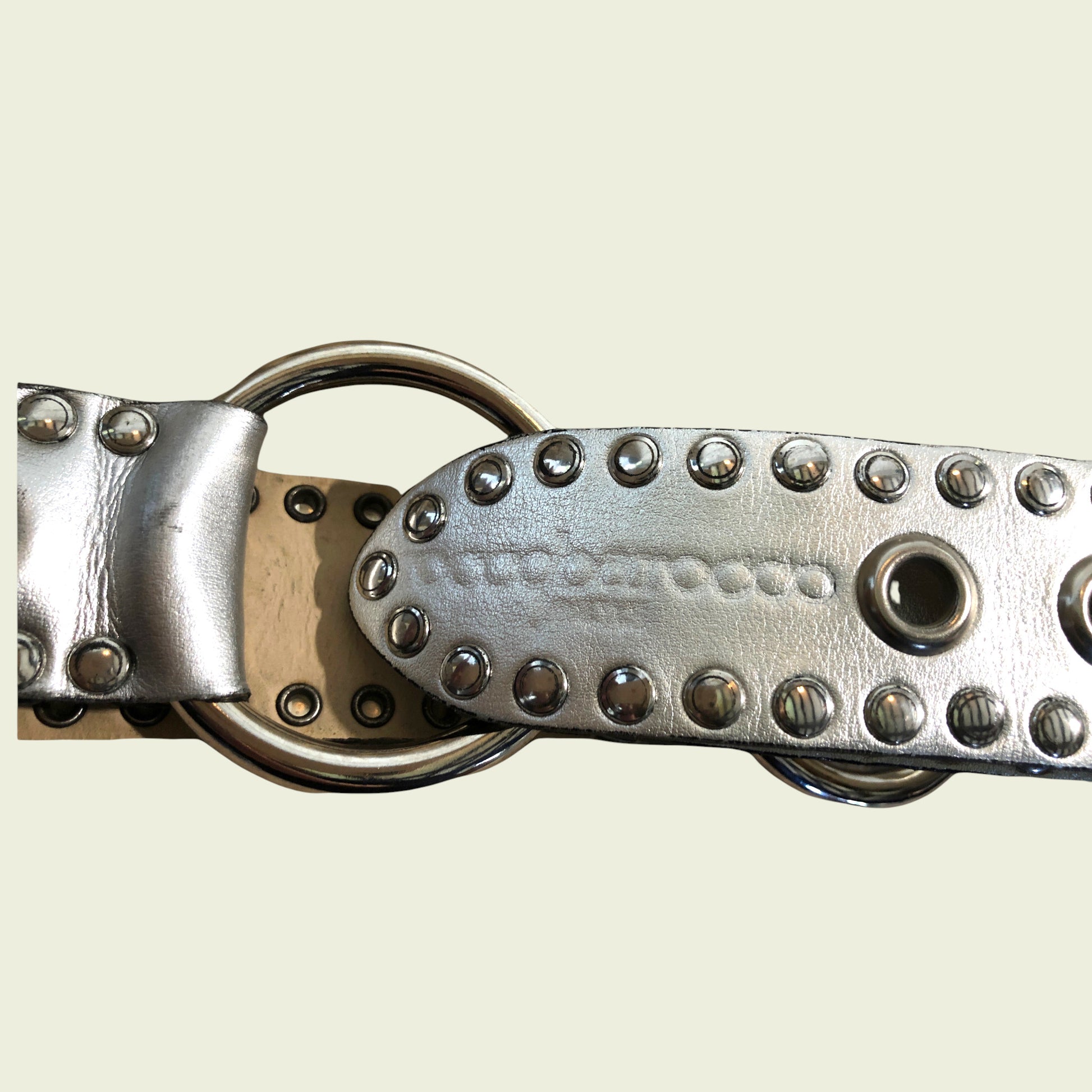 Silver studded belt on a beige background