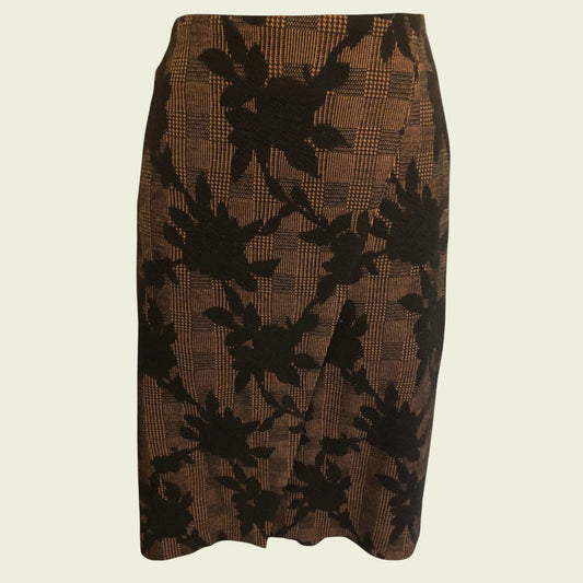 Brown skirt with black floral pattern on a beige background