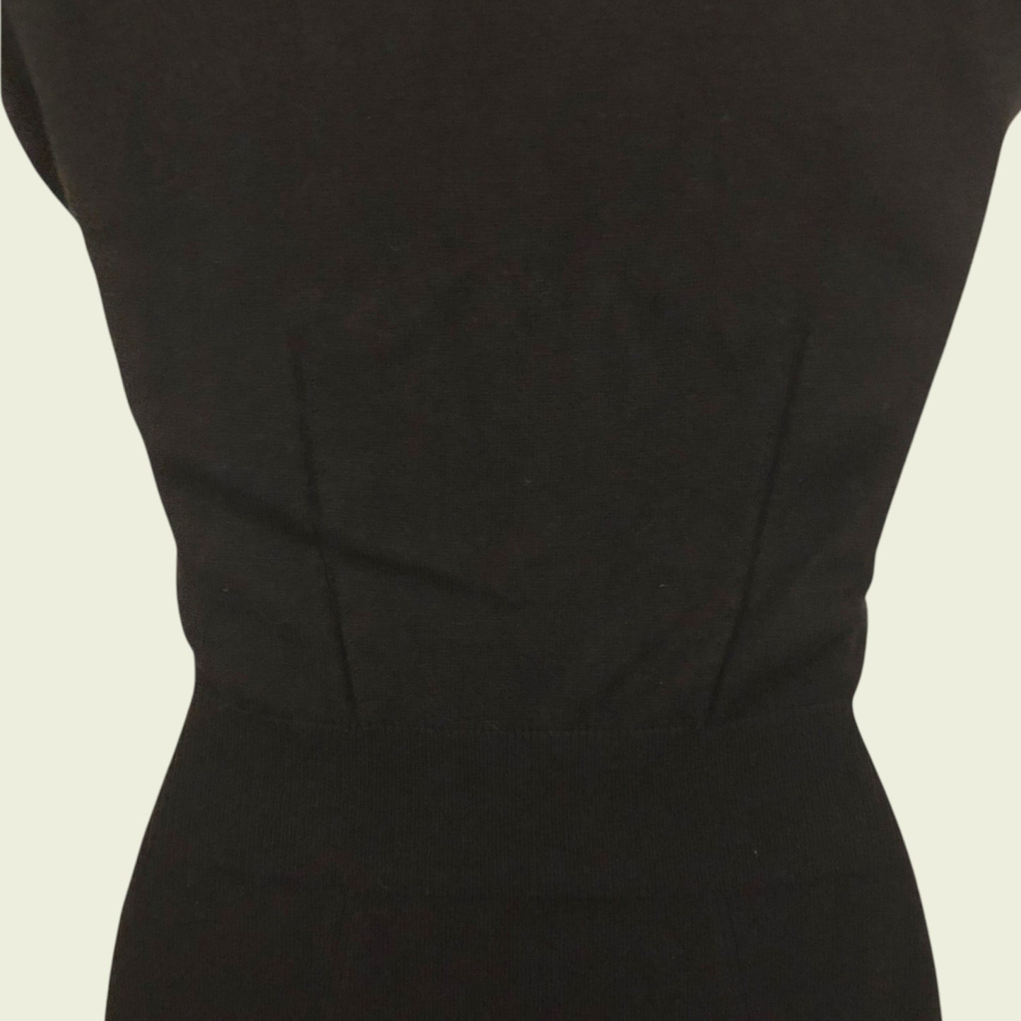 Black dress on a beige background