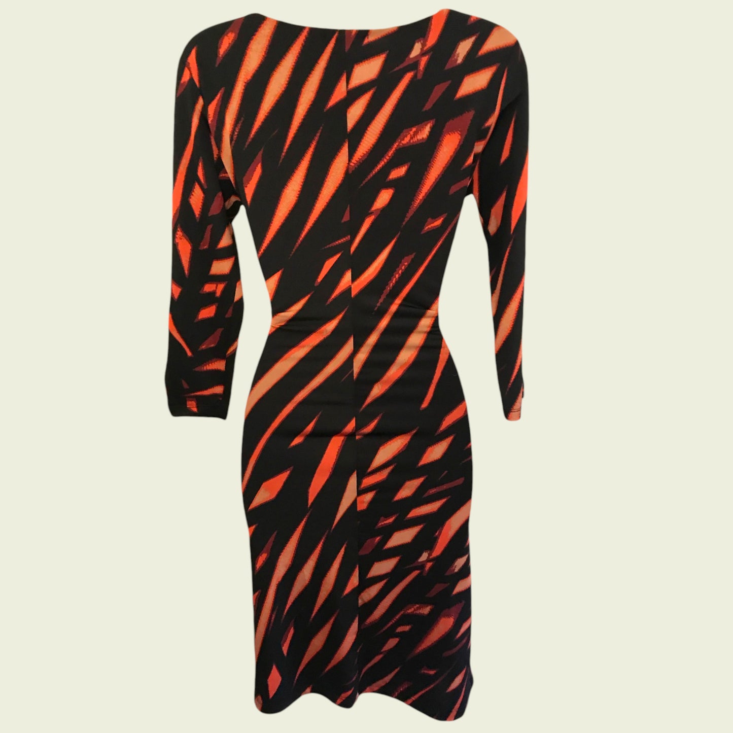 Black and orange patterned dress on a beige background