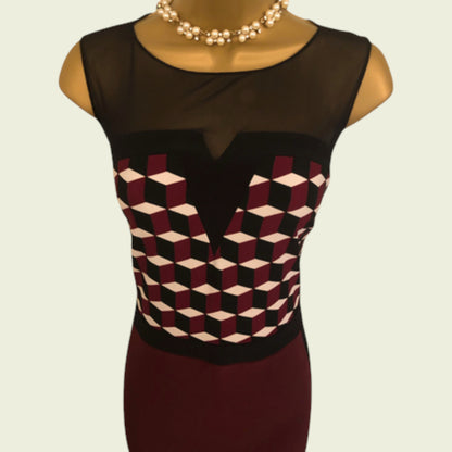 Mannequin wearing a black sleeveless dress with geometric pattern on a beige background