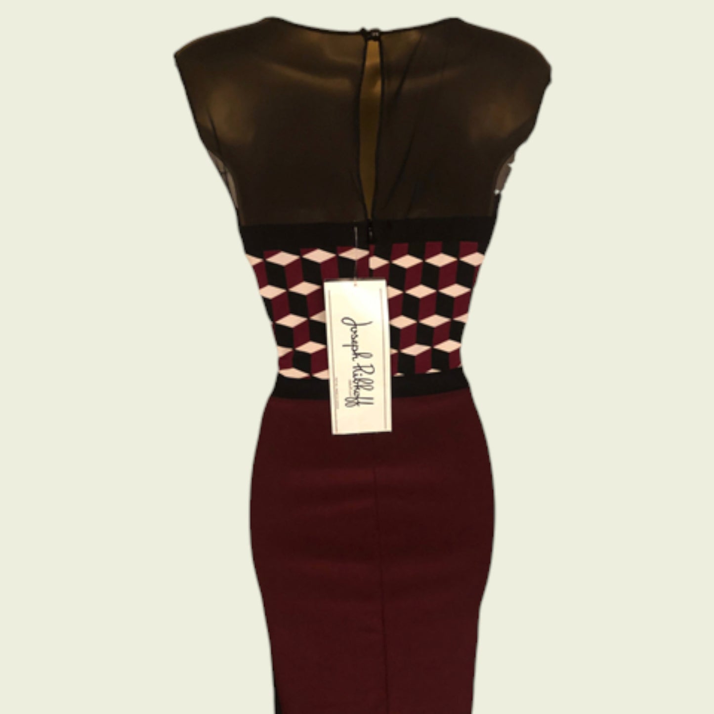 Dress with geometric pattern and brand label on a beige background