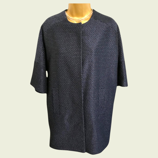 Navy blue textured dress on a mannequin against a light gray background
