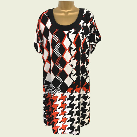 Mannequin wearing a dress with black, white, and red geometric pattern on a light gray background