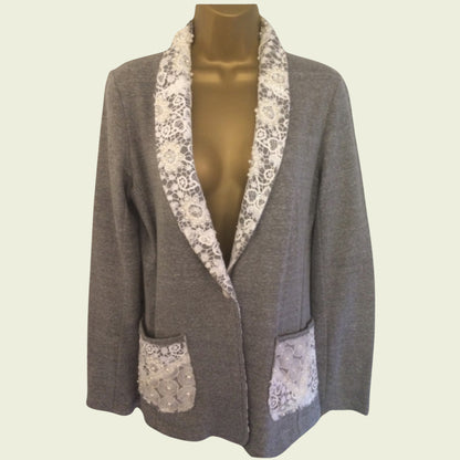 Gray blazer with lace trim on a mannequin against a beige background
