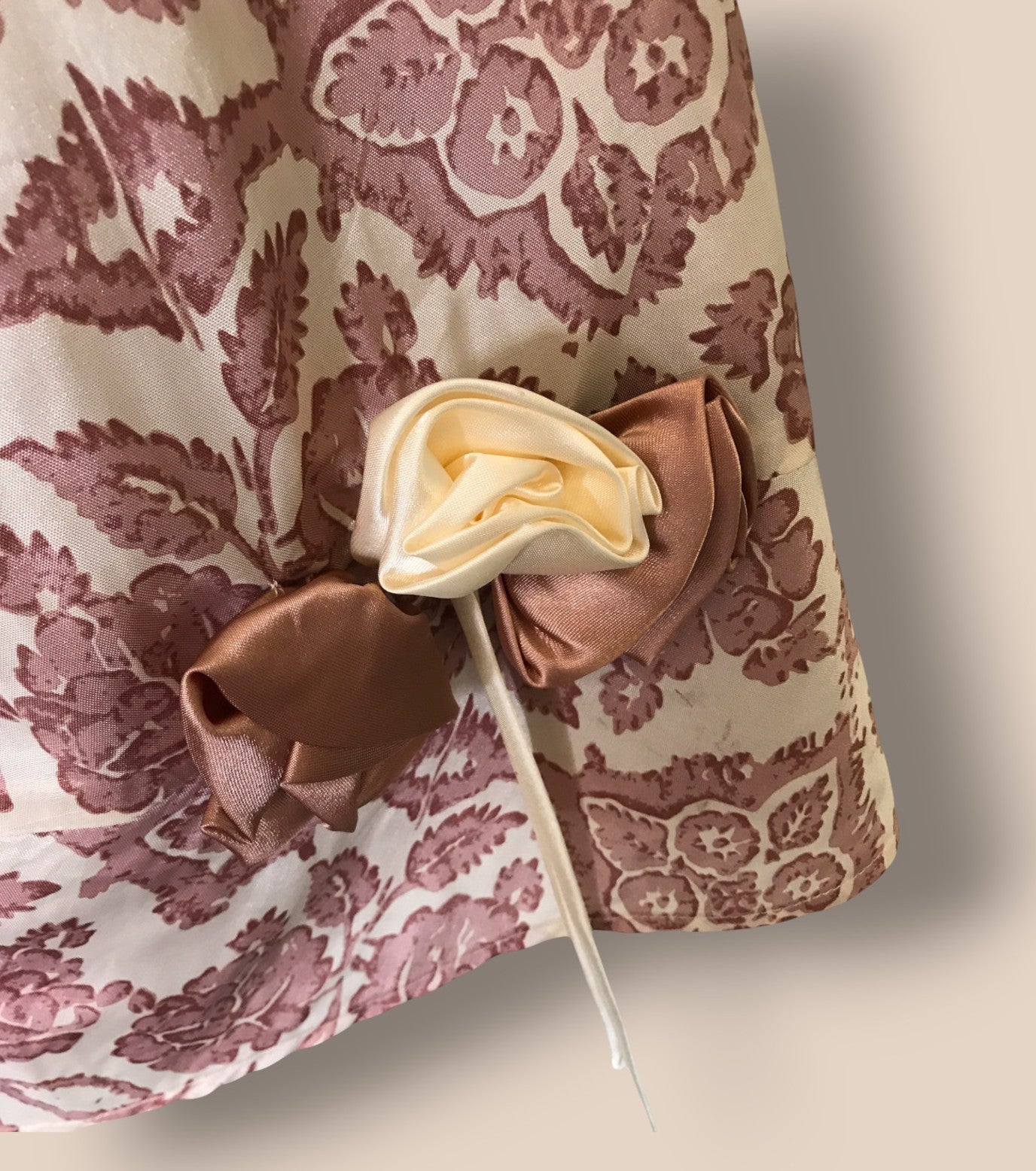 Decorative flower on a stick against a patterned fabric background