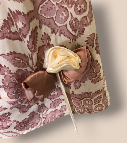 Decorative flower on a stick against a patterned fabric background