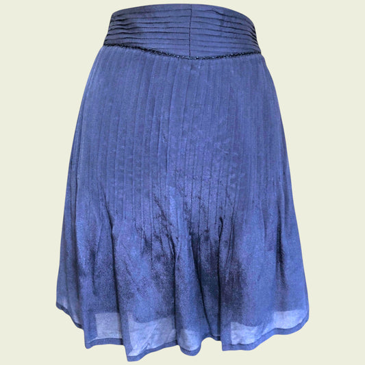 Blue pleated skirt on beige background