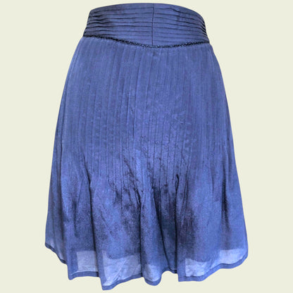 Blue pleated mini skirt on beige background