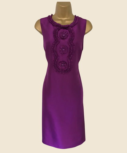 Purple dress with decorative elements on a beige background