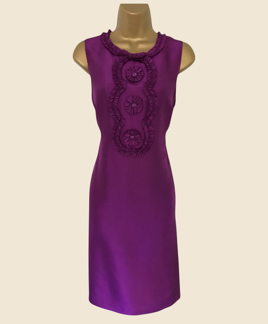 Purple dress with decorative elements on a beige background