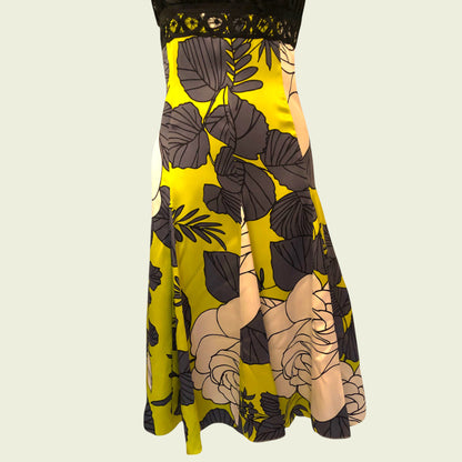 Black and yellow dress with black floral pattern on a beige background