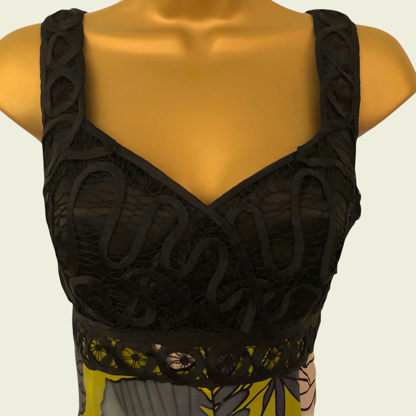 Black lace top on a mannequin with a neutral background