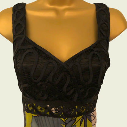 Black lace top on a mannequin with a neutral background