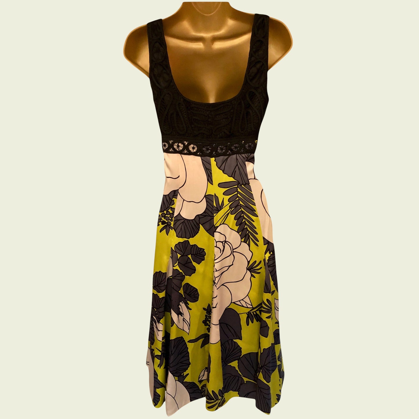 Floral dress on a mannequin against a beige background