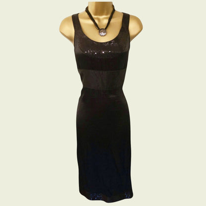 Black dress on a mannequin with a plain background