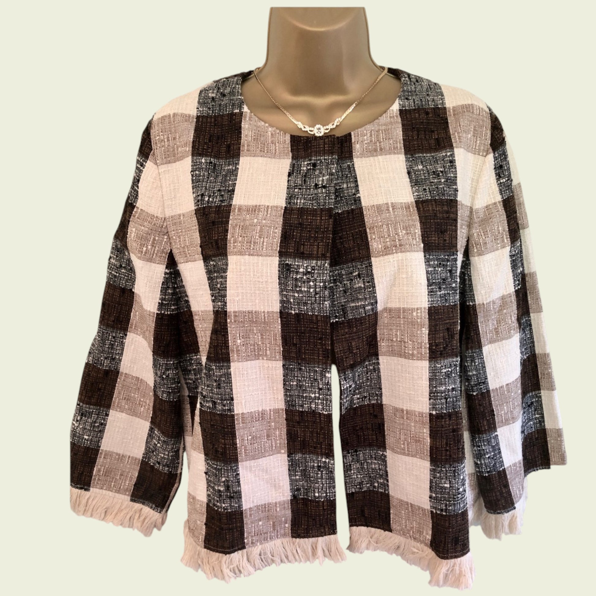 Plaid patterned garment on a mannequin against a plain background