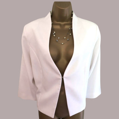 White blazer on a mannequin against a gray background