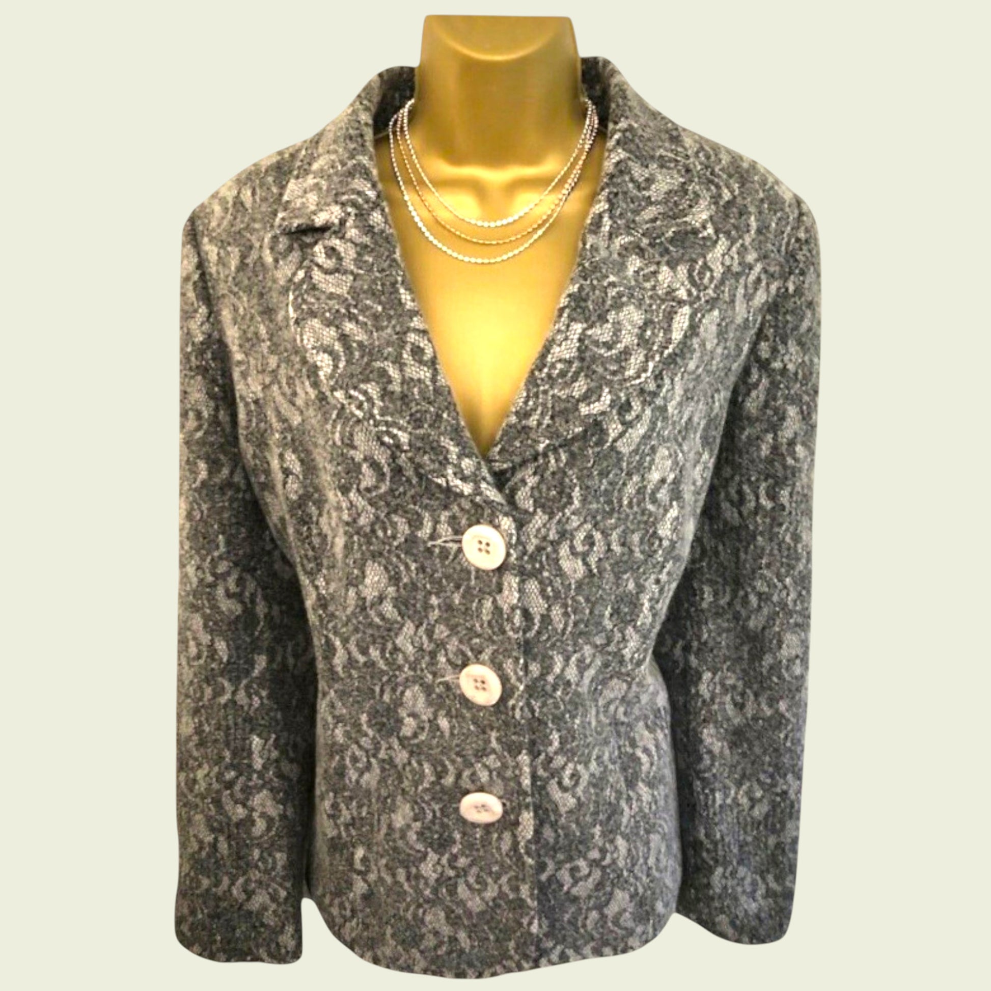 Patterned blazer on a mannequin with a plain background
