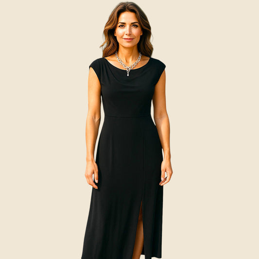 Woman wearing a black dress with a plain background
