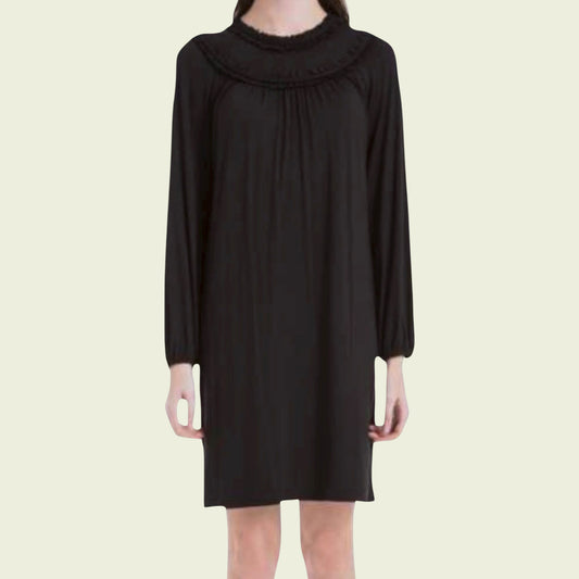 Black dress with a ruffled neckline on a beige background