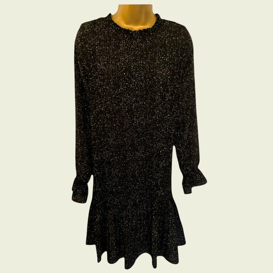 Black and white polka dot pleated dress on beige background