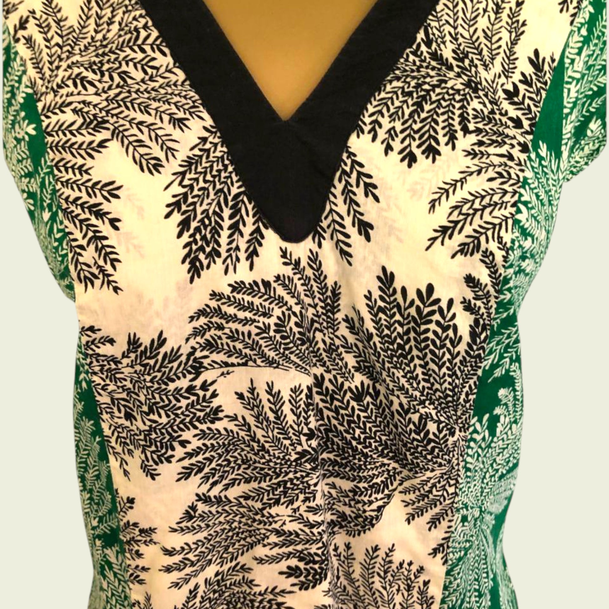 Close-up of a patterned garment with black leaf-like design on a light background
