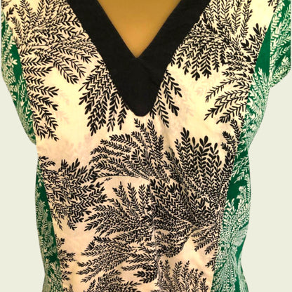 Close-up of a patterned garment with black leaf-like design on a light background