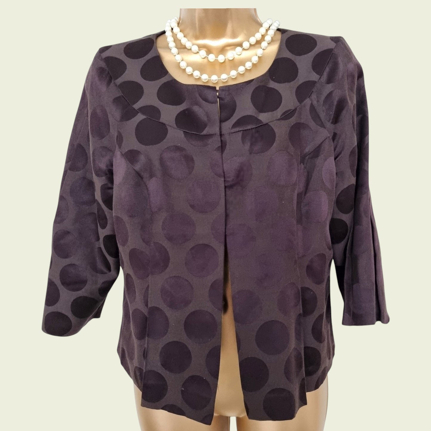 Brown jacket on a mannequin with a plain background