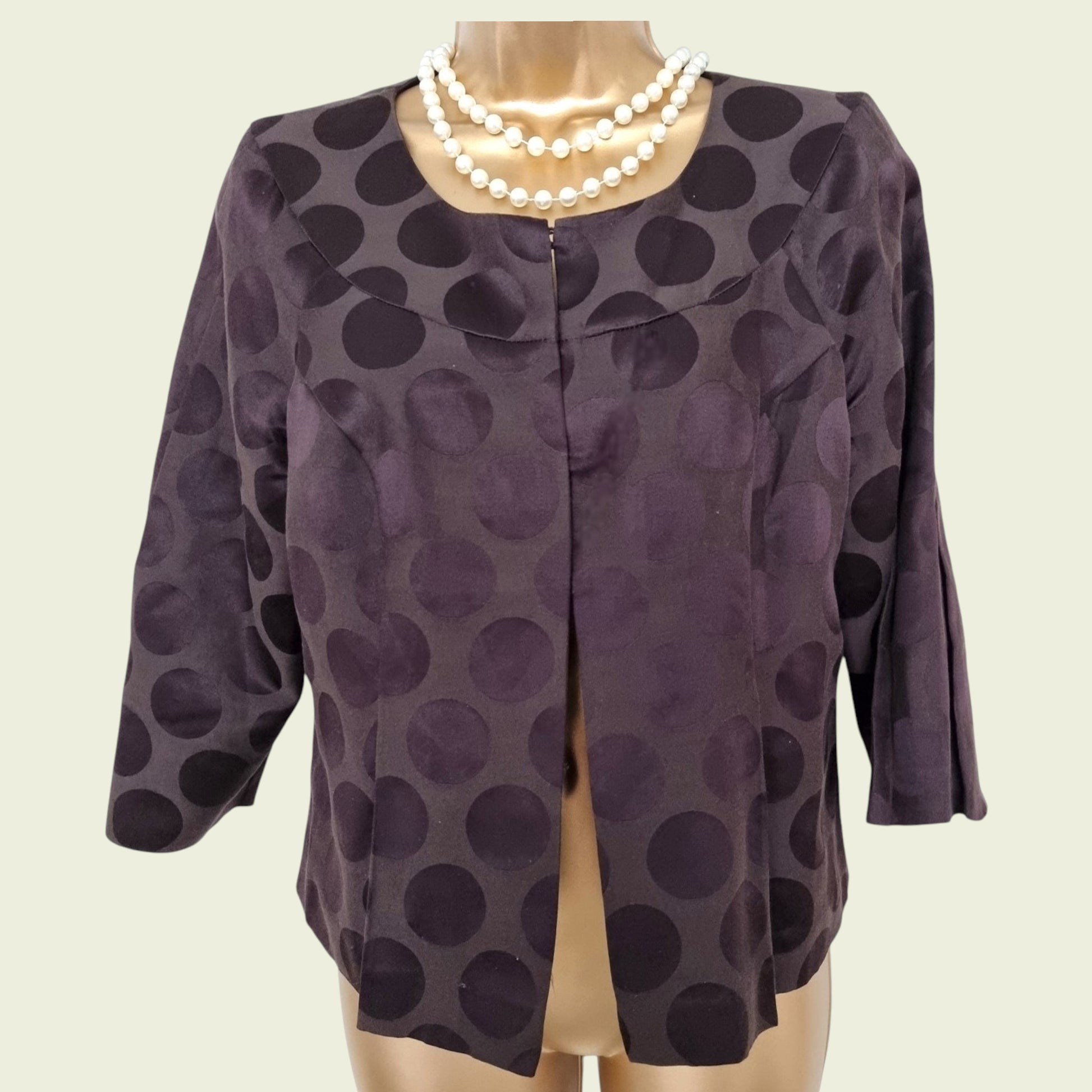 Brown jacket on a mannequin with a plain background