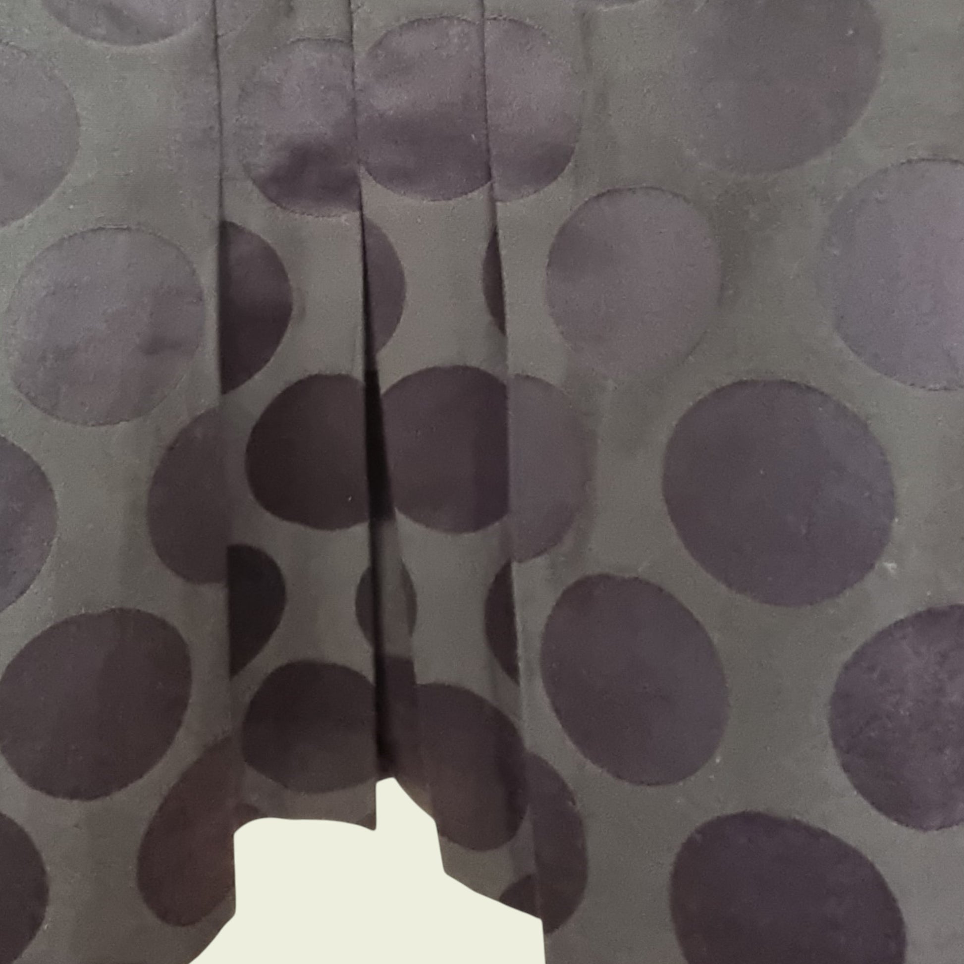 Close-up of a fabric with brown dots on a gray background