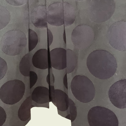 Close-up of a fabric with brown dots on a gray background