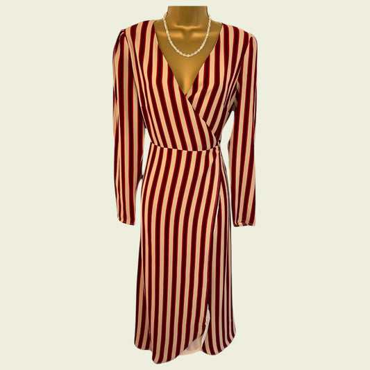 Red and white striped dress on a mannequin against a beige background