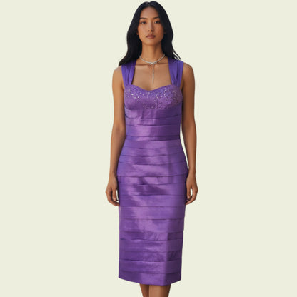 Woman wearing a purple dress with a beige background