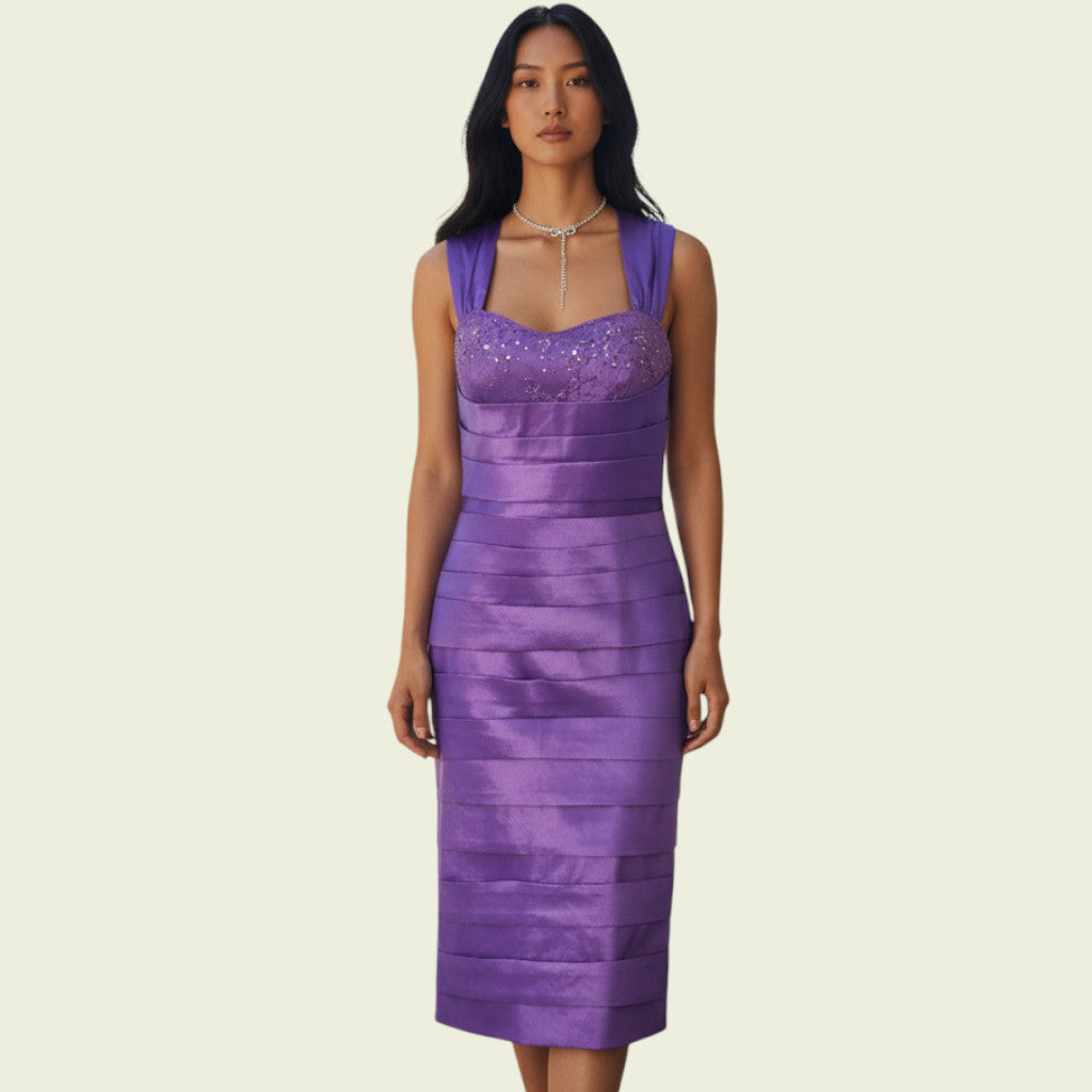 Woman wearing a purple dress with a beige background