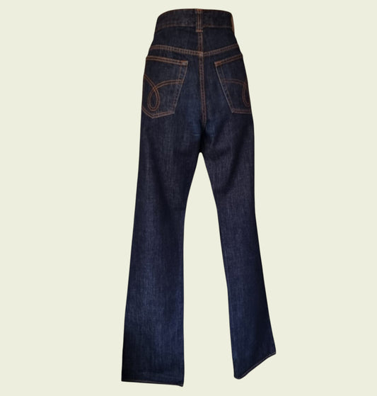 Pair of dark blue jeans on a beige background