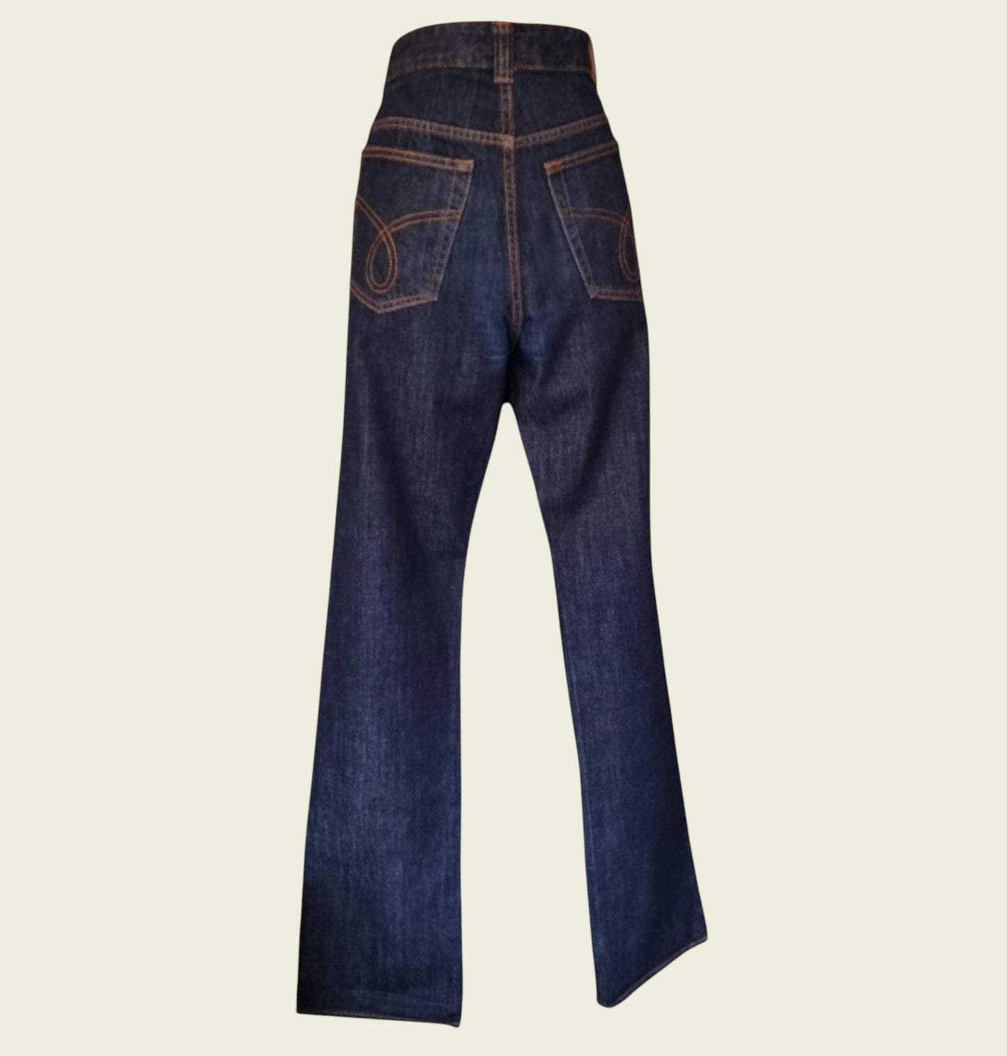 Pair of blue jeans on a beige background