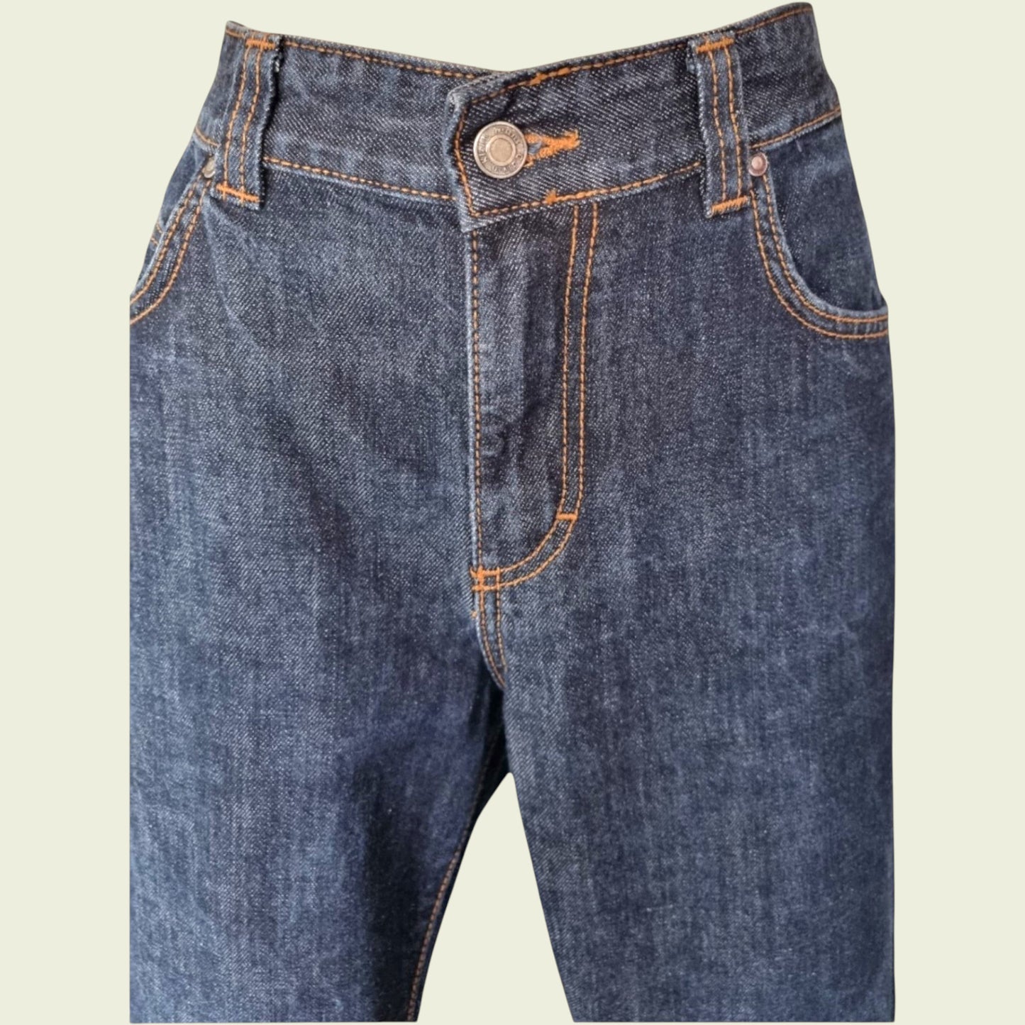 Pair of blue jeans on a beige background