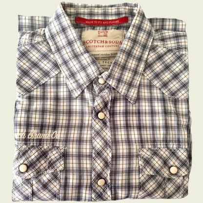 Plaid shirt with visible branding on a light background