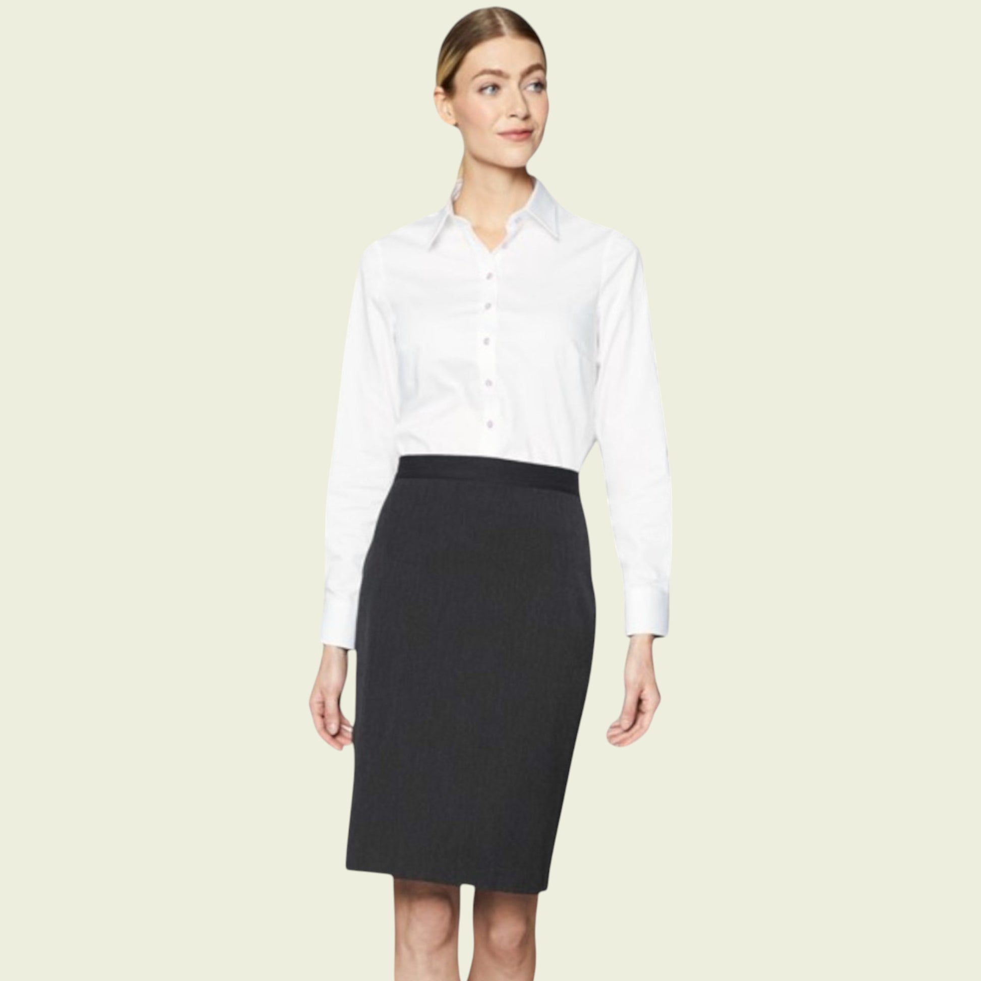 Woman wearing a white shirt and black skirt on a beige background