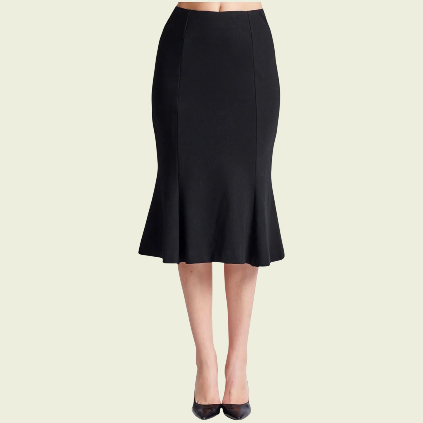 Black pencil skirt worn by a person on a beige background