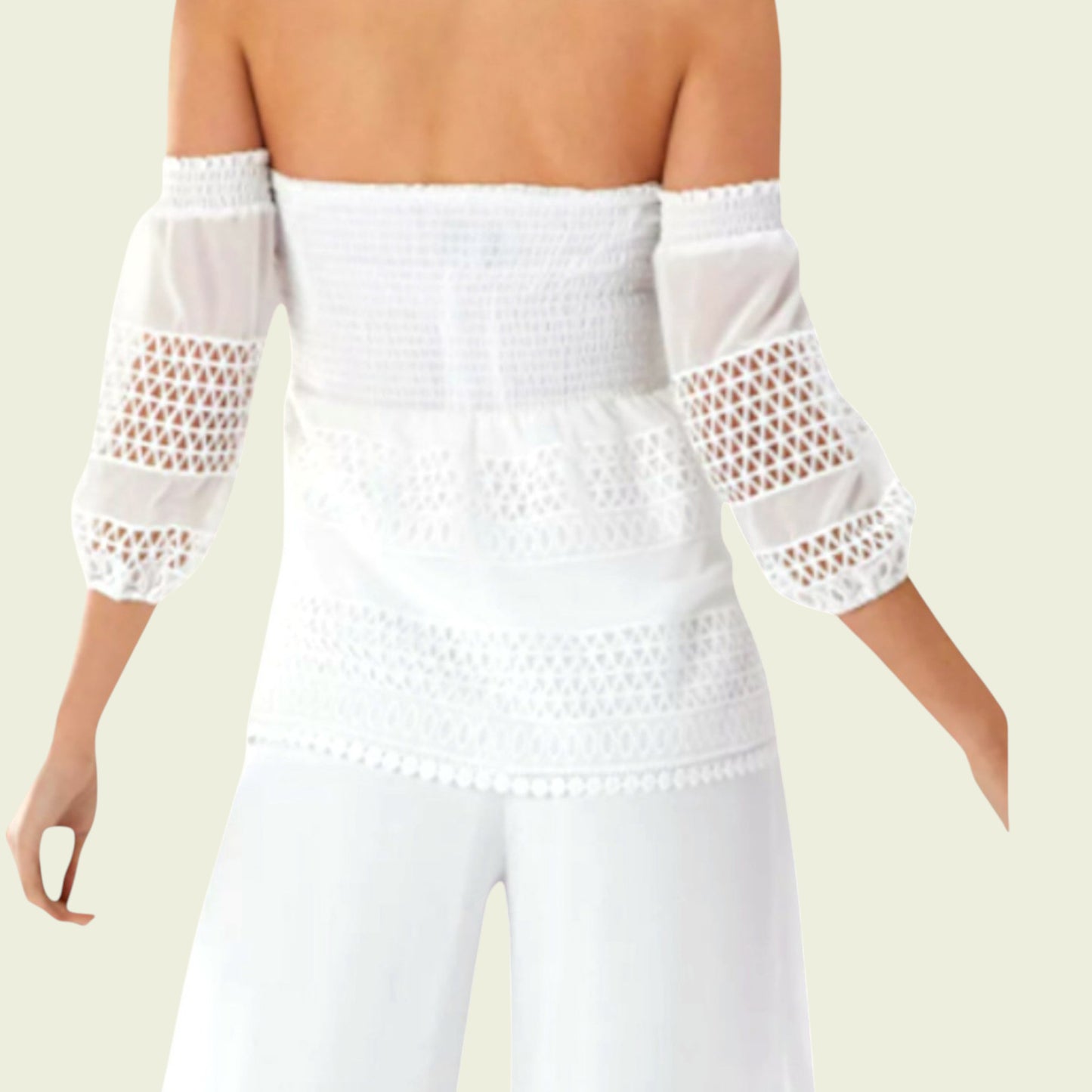White off-shoulder top with mesh sleeves on a plain background