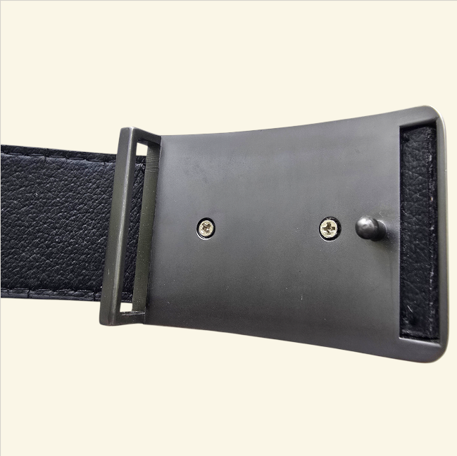Black leather belt with a metal buckle on a light beige background