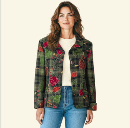 Model wearing a women's long-sleeve plaid jacket with a red and green maple leaf pattern, displayed on a mannequin torso against a light beige background.