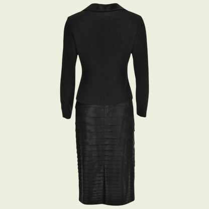 Black suit with long sleeves and a textured skirt on a beige background