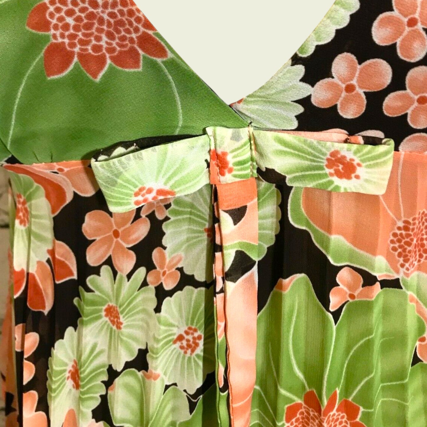 Bow detail on floral top on beige background