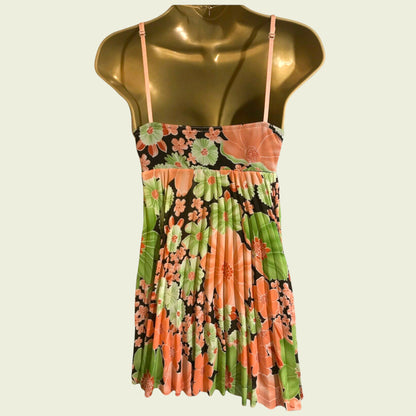 Floral top on a mannequin against a plain background